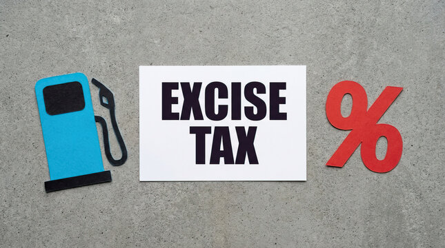 Excise tax concept with paper cutout of fuel pump and red percentage symbol on concrete background, symbolizing taxation on fuel and percentage rates affecting cost