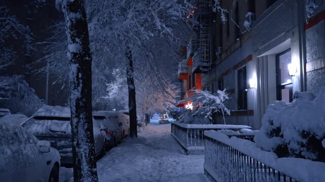 Heavy snowstorm hit the modern city. Stroll by the street covered with thick layer of snow at night.