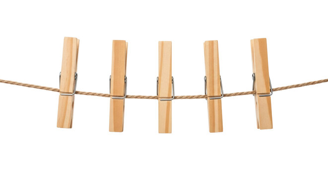 Five wooden clothespins hanging on a clothesline, ready to dry the laundry