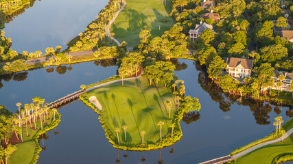 Fototapeta premium Aerial view of beautiful golf course landscape near oceanfront beach on lowcountry Kiawah Island near Charleston, South Carolina during morning sunrise