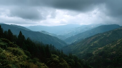 Fototapeta premium A vast moody landscape of rolling green mountains under a dramatic overcast sky creating a serene and natural atmosphere