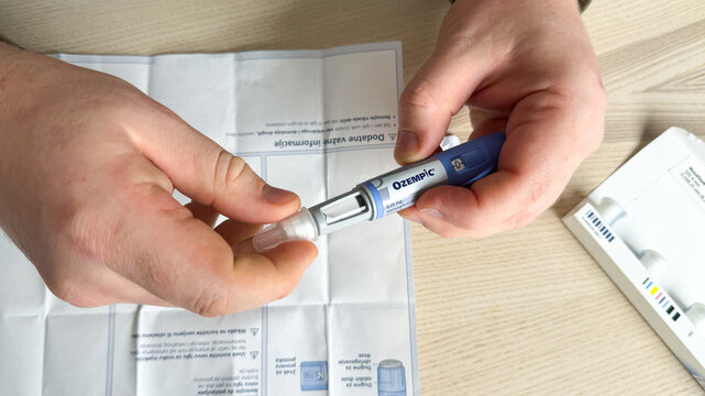 Male Caucasian hands adjust vibrant pen injector on sterile paper, health innovation spotlight, World Health Day, Biotech Carnival Ozempic, GLP 1, Semaglutide, January 5 2026, Subotica, Serbia