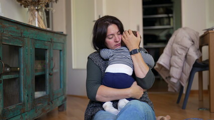 Fototapeta premium Mother gently comforting baby, holding them close with a tender embrace, showcasing nurturing care, emotional connection, and warmth in a cozy indoor family setting