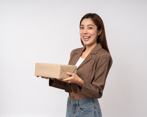 Fototapeta premium Young excited beautiful asian woman with parcel cardboard standing on isolated background. Cheerful female holding lot of parcel box receive from the delivery service shopping online application