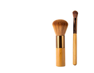 Two makeup brushes on a black background, one large fluffy, one small pointed