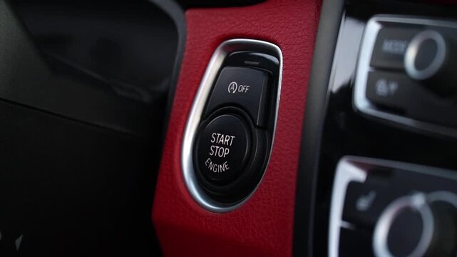 Close-up sequence of modern vehicle ignition button being activated, showcasing the sleek design and functionality of the start-stop engine feature in a contemporary car interior