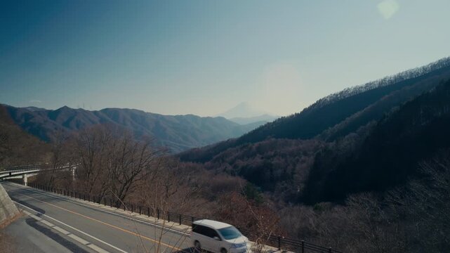 Outdoor scenic shot of Mount Fuji beyond layered mountains.