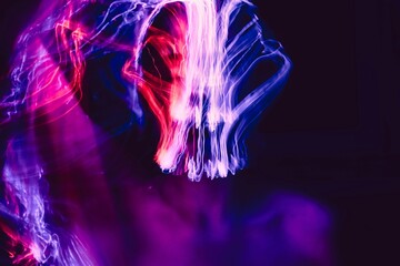 Abstract Electric Symphony: A vibrant display of light and motion, showcasing streaks of color against a dark backdrop, creating an artistic representation of energy and movement.