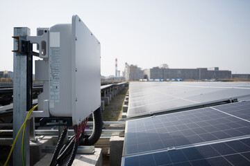 Solar power station with inverter and photovoltaic panel array under clear daylight