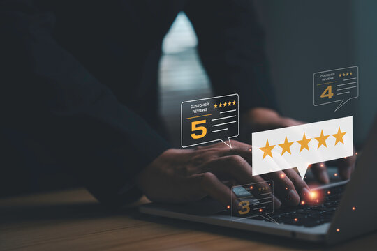 Customer reviews and five star rating feedback concept. Businessman typing on keyboard with online satisfaction survey, digital marketing reputation management and e commerce excellent evaluation.