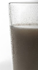 Cold refreshing beer foam close-up in frosty glass with bubbles and texture