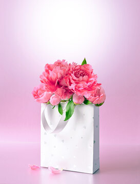 Beautiful gift box with pink peonies. Concept of internet shopping, flower shop. Mothers or Women's Day.