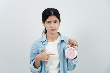 Stress Asia young woman show clock alarm, lady is late appointment or work or class study,...