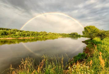 Foto auf Acrylglas Wiese, Sumpf Rainbow over the Dnieper River after rain on a summer day, forests, meadows, fields.  © Nadzeya Pakhomava