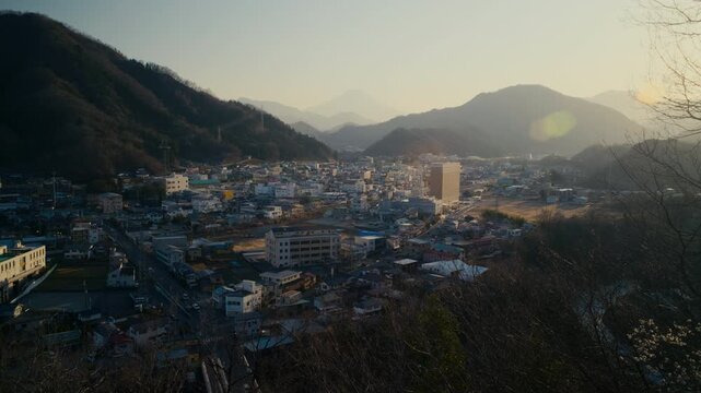 High vantage panorama showing Mount Fuji and Otsuki cityscape.
