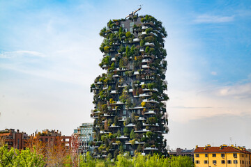 Obraz premium Vertical forest building. Bosco Verticale skyscraper in Milan. Sustainable architecture. Vertical forest tower in Italy. Modern apartments by greenery.