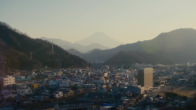 Serene panoramic view of Fuji mountain above Otsuki rooftops.