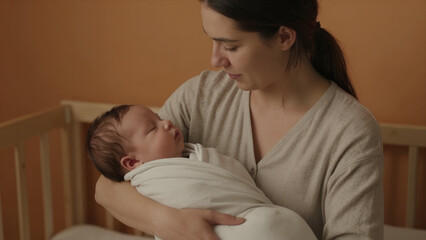 Fototapeta premium Mother Holding Her Baby In A Nursery, Tender Moment Of Love And Care, Portrait Orientation