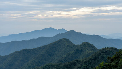 Fototapeta premium Panoramic View Of Layered Mountains Under A Cloudy Sky During Daylight