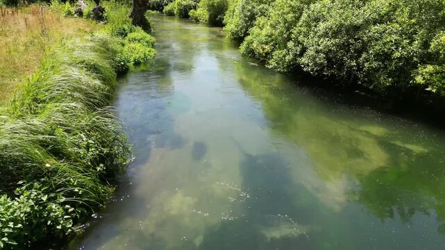 Drone closely following idillic river in the countryside 4k drone