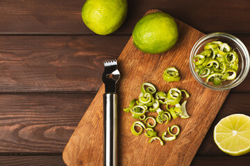 Fresh lime on a textured table background. Whole limes and slices in a bowl. Citrus. Vitamin C....
