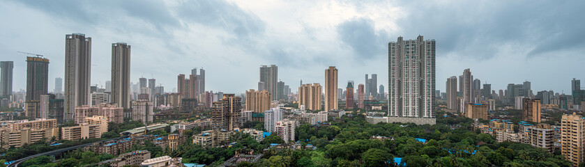 Fototapeta premium Panoramic view of the skyline of Mumbai showcasing dense urban architecture, high-rise buildings, and the vibrant coastal cityscape.