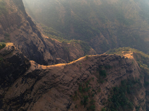 Dramatic rocky landscape of Sandhan Valley, known as the &ldquo;Valley of Shadows.&rdquo; Massive basalt cliffs, narrow canyon passages, and rugged terrain create a striking natural scene in the Western Ghats.