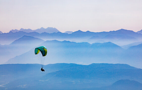 Paraglider soaring high above the mountains in Carinthia Austria