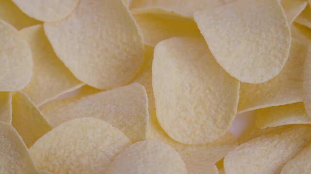 Salty crispy snack display, Close shot of seasoned potato chips with layered texture, Detailed image of crisp potato snacks showcased for marketing and recipe presentation
