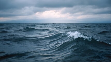 Moody ocean seascape with dark choppy waves and a dramatic cloudy sky highlighting nature s raw power