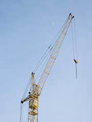 Tall Yellow Crane Against Blue Sky