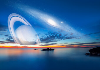 Andromeda galaxy over the sea at sunset Saturn planet in the background "Elements of this image furnished by NASA" © muratart