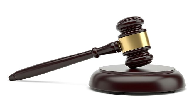 A close-up of a wooden gavel and sound block, commonly used in legal proceedings