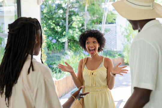 Yellow sundress fluttering in doorway while woven straw tote and wide-brim hat resting on porch