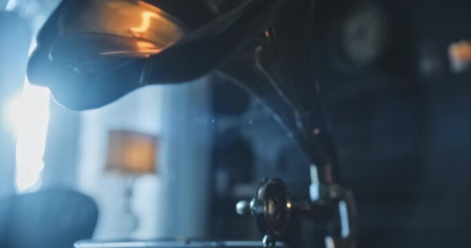 Cinematic, closeup, tilt shot from rotating turntable of phonogram to it's golden horn