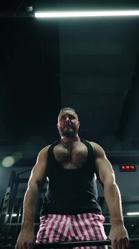 Intense close-up of a muscular athlete performing heavy deadlift reps in a dimly lit gym, showcasing strength, focused effort, and strain during a demanding powerlifting session