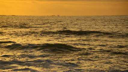 Obraz premium Sunset with orange colours over the calm ocean.