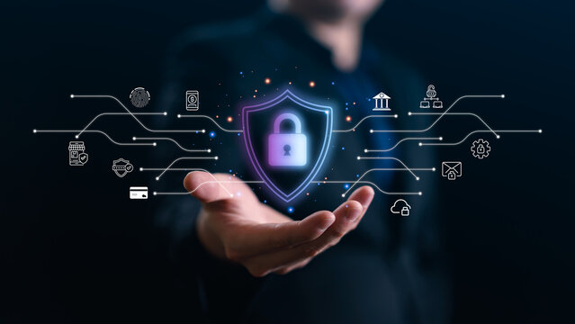 Businessman hand holding virtual shield with padlock and network icons. Concept of cyber security, data protection, privacy, and digital banking safety in futuristic corporate world.