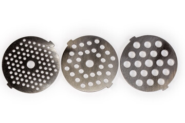 Different hole plates of household meat grinder on white background
