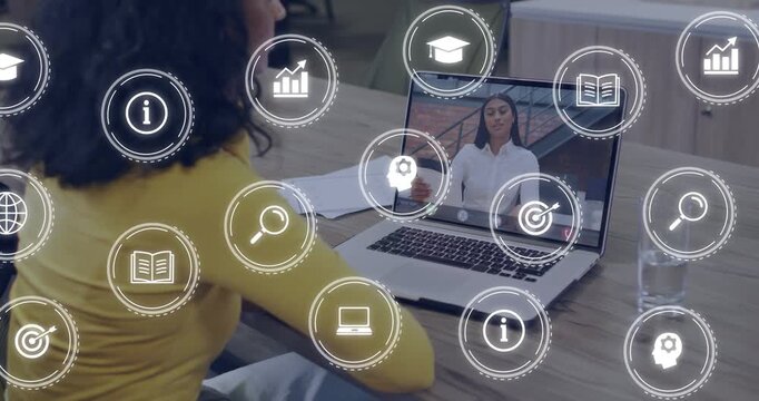 Seated woman watching laptop while remote host presenting, causing business icons moving over frame