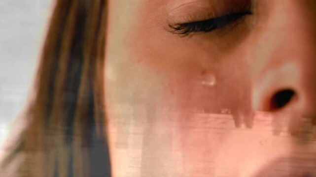 Woman in tight closeup showing tear tracking cheek and eyelid closing while tech overlays shifting