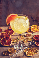 Grapefruit and orange cocktail in a round glass.