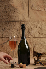 Bottle of sparkling ros&Atilde;&copy; wine with a glass and carnival mask