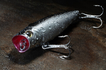 Topwater fishing crankbait just out of the water at daybreak