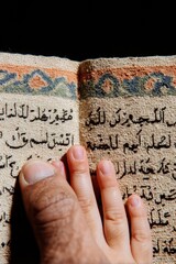 Muslim Child and Father Reading Quran Together Close Up, Hands Pointing at Arabic Script for Islamic Education, Religious Family Learning during Ramadan and Kadir Gecesi