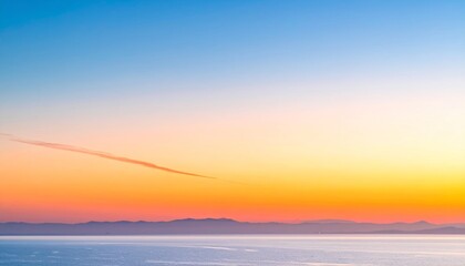 Fototapeta premium Horizon View of Blue Ocean and Golden Sunset Sky with Cloud Trails