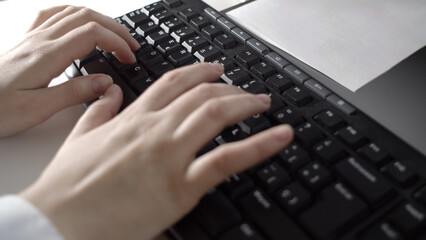 close up view of woman 's hands typing on a keyboard. business concept