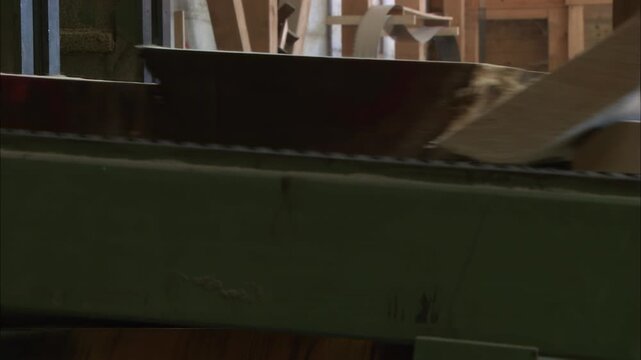 Wooden board moving through industrial woodworking machine