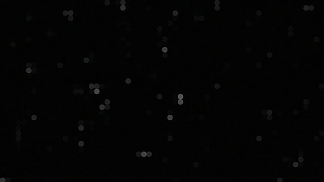 Flickering pattern of white and gray dots creating digital bokeh effect on black background. Abstract animation background