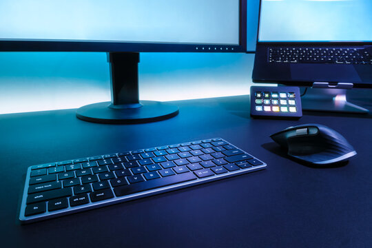Modern Computer Desk Setup With Dual Monitors Keyboard Mouse And Streaming Equipment